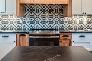 A modern kitchen with a decorative tile backsplash and wooden cabinetry, showcasing Bayside Builders Group's expertise in Bay Area home remodeling and kitchen renovations.