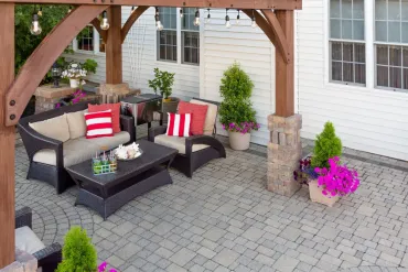 A beautifully designed outdoor patio features comfortable wicker seating and vibrant potted plants, showcasing Bayside Builders Group’s expertise in enhancing Bay Area homes with elegant and functional outdoor living spaces.