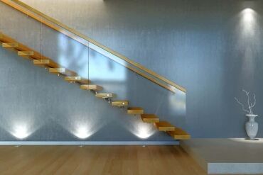 Modern floating wooden staircase with subtle lighting underneath, illustrating sleek and innovative home design, ideal for contemporary Bay Area remodels by Bayside Builders Group.