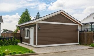 A well-constructed accessory dwelling unit (ADU) with brown siding and a white door, showcasing Bayside Builders Group’s expertise in modern home renovation and construction in the Bay Area.