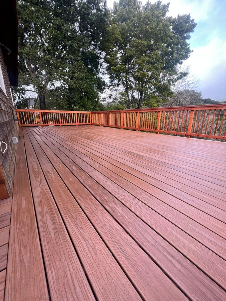 A spacious wooden deck with rich, natural tones, showcasing Bayside Builders Group's expertise in outdoor home improvement in the Bay Area.