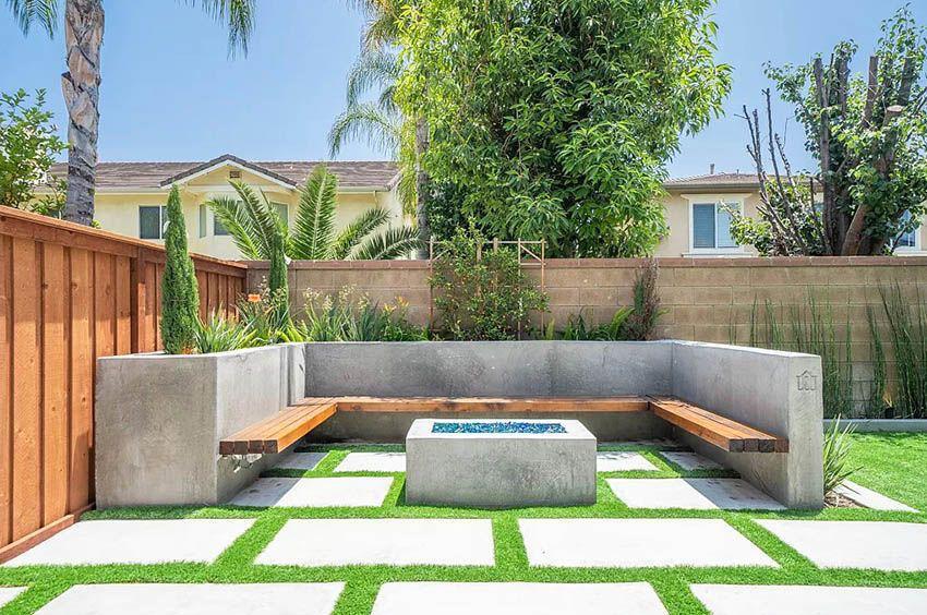 Modern outdoor seating area featuring wooden benches and a contemporary fire pit, perfect for Bay Area backyard remodeling and enhancement by Bayside Builders Group.