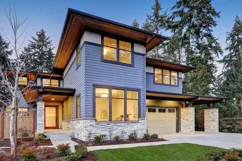Modern two-story home with sleek blue siding and large windows, exemplifying Bay Area style and quality construction by Bayside Builders Group.
